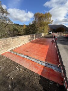 Bridge deck showing new spray applied waterproofing, bridge joints and subsurfacedrainage immediately prior to carriageway resurfacing.
